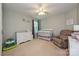 Neutral bedroom with a crib, changing table, and comfortable armchair, perfect for a Bedroom at 4018 Harmattan Dr, Denver, NC 28037
