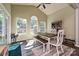 Dining area featuring natural lighting with windows, wooden floors, and an inviting breakfast table at 4018 Harmattan Dr, Denver, NC 28037