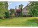 Inviting single-story home with lush landscaping and manicured lawn, set on a sunny day at 4018 Harmattan Dr, Denver, NC 28037