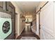 Inviting foyer featuring hardwood floors, a modern barn door, and decorative wall art at 4018 Harmattan Dr, Denver, NC 28037