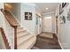Bright foyer with hardwood floors, a carpeted staircase, and stylish decor at 4018 Harmattan Dr, Denver, NC 28037