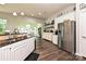 Bright kitchen with white cabinetry, stainless steel appliances, and hardwood flooring at 4018 Harmattan Dr, Denver, NC 28037