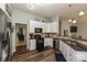 Efficient kitchen layout featuring black appliances, granite countertops, and wood floors at 4018 Harmattan Dr, Denver, NC 28037