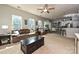Spacious living room with plush sofas, neutral carpet, and a view into the modern kitchen at 4018 Harmattan Dr, Denver, NC 28037