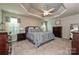 Primary bedroom with a trey ceiling, plush carpet, and decorative bedding at 4018 Harmattan Dr, Denver, NC 28037
