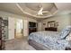 Large primary bedroom featuring neutral tones, trey ceiling, and an attached en-suite bathroom at 4018 Harmattan Dr, Denver, NC 28037