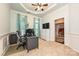 Well-lit office space with wainscoting, tray ceiling, and neutral carpet at 4018 Harmattan Dr, Denver, NC 28037