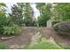 Playground with a swing set and playhouse, offers a fun space for children to enjoy outdoor recreation and playtime at 4018 Harmattan Dr, Denver, NC 28037