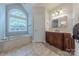 Bright bathroom with soaking tub, vanity, and large window at 4113 Hoffmeister Dr, Waxhaw, NC 28173