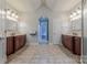 Spacious bathroom featuring dual vanities, tiled floors, and modern lighting at 4113 Hoffmeister Dr, Waxhaw, NC 28173