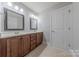 Double vanity bathroom with tile flooring, wood cabinets, and white walls at 4113 Hoffmeister Dr, Waxhaw, NC 28173