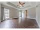 Spacious bedroom featuring a tray ceiling, fan, and large windows at 4113 Hoffmeister Dr, Waxhaw, NC 28173