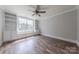 Bedroom boasts a large window, built in bookshelves, a window seat, ceiling fan, and hard flooring at 4113 Hoffmeister Dr, Waxhaw, NC 28173