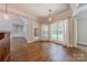 Bright breakfast nook featuring hardwood floors, windows with curtains and views into the living room and kitchen at 4113 Hoffmeister Dr, Waxhaw, NC 28173