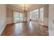 Dining area with hardwood floors, chandelier, and a large window offers natural light and views at 4113 Hoffmeister Dr, Waxhaw, NC 28173