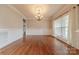 Hardwood floors, classic chandelier, and large window with natural light make up the dining area at 4113 Hoffmeister Dr, Waxhaw, NC 28173