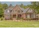 Beautiful brick home with a well-manicured lawn and tasteful landscaping. Traditional home design at 4113 Hoffmeister Dr, Waxhaw, NC 28173