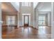 Foyer features hardwood floors, soaring ceilings, and a decorative wood front door at 4113 Hoffmeister Dr, Waxhaw, NC 28173