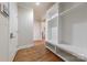 Hallway featuring built in cubbies, hardwood flooring and neutral paint at 4113 Hoffmeister Dr, Waxhaw, NC 28173