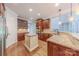 Stylish kitchen featuring granite countertops, wooden cabinets, stainless steel appliances, and hardwood floors at 4113 Hoffmeister Dr, Waxhaw, NC 28173