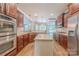 Spacious kitchen boasts stainless steel appliances, granite counters, hardwood floors, and a bright, open layout at 4113 Hoffmeister Dr, Waxhaw, NC 28173