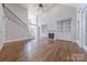 Spacious living room featuring a staircase with iron railings, fireplace with built-ins and hardwood floors at 4113 Hoffmeister Dr, Waxhaw, NC 28173