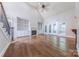 Living room with hardwood floors, fireplace, built-in shelving, and French doors to the outside at 4113 Hoffmeister Dr, Waxhaw, NC 28173