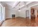 Inviting living room featuring a fireplace, hardwood floors and a coffered ceiling with elegant chandelier at 4113 Hoffmeister Dr, Waxhaw, NC 28173