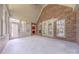 Bright sunroom featuring brick walls, large windows with backyard views, and tile flooring at 4113 Hoffmeister Dr, Waxhaw, NC 28173