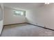 Bedroom boasts ample natural light with neutral carpet and white walls providing a serene and inviting atmosphere at 467 16Th Nw Ave, Hickory, NC 28601