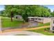 Well-maintained single-story home with a spacious driveway, attached carport, and mature trees in a tranquil setting at 467 16Th Nw Ave, Hickory, NC 28601