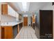 Galley kitchen features modern appliances, tile flooring, and a skylight that floods the space with natural light at 467 16Th Nw Ave, Hickory, NC 28601
