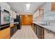Galley kitchen features modern appliances, tile flooring, and a skylight that floods the space with natural light at 467 16Th Nw Ave, Hickory, NC 28601
