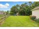 Expansive back yard featuring lush grass, wooden fence and a great play area at 5359 Lake Glenn Dr, Stanfield, NC 28163
