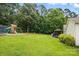This lovely back yard has a swing set and trampoline near the lush green trees at 5359 Lake Glenn Dr, Stanfield, NC 28163