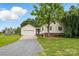 Inviting single-story home featuring attached garage, vinyl siding, and lush landscaping at 5359 Lake Glenn Dr, Stanfield, NC 28163