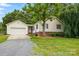 Inviting single-story home featuring attached garage, vinyl siding, and lush landscaping at 5359 Lake Glenn Dr, Stanfield, NC 28163