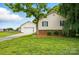 Single-story home featuring an attached garage, brick accents, a lush lawn, and mature landscaping at 5359 Lake Glenn Dr, Stanfield, NC 28163
