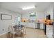 Well-lit kitchen with white cabinetry, stainless steel appliances, and a cozy breakfast nook at 5359 Lake Glenn Dr, Stanfield, NC 28163