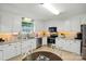 Contemporary kitchen with white cabinets, stainless steel appliances, and a dining table for casual meals at 5359 Lake Glenn Dr, Stanfield, NC 28163