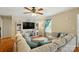 Spacious living room featuring a ceiling fan, entertainment center and sectional sofa with decorative pillows at 5359 Lake Glenn Dr, Stanfield, NC 28163