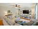 Inviting living room with a comfortable sectional sofa, media center, and warm hardwood floors at 5359 Lake Glenn Dr, Stanfield, NC 28163