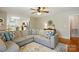 Cozy living room and open floorplan with a large sectional sofa, ceiling fan, and a view into the kitchen at 5359 Lake Glenn Dr, Stanfield, NC 28163