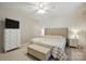 Inviting primary bedroom with a tufted headboard, ceiling fan and neutral decor at 5359 Lake Glenn Dr, Stanfield, NC 28163