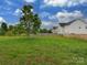Large backyard has green grass, a large tree, and a wooden fence outlining the property at 5607 Fulton Ridge Dr, Indian Trail, NC 28079