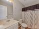 Well-lit bathroom with a toilet, vanity, mirror and a shower with a decorative shower curtain at 5607 Fulton Ridge Dr, Indian Trail, NC 28079