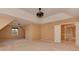 A large bedroom with a tray ceiling, fan fixture, windows, and carpeted floors at 5607 Fulton Ridge Dr, Indian Trail, NC 28079