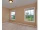 Carpeted bedroom with two large windows offering a bright and airy feel at 5607 Fulton Ridge Dr, Indian Trail, NC 28079