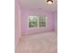 Pink bedroom featuring a large window with blinds for privacy at 5607 Fulton Ridge Dr, Indian Trail, NC 28079