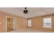 A large bedroom with a tray ceiling, fan fixture, windows, and an ensuite bathroom at 5607 Fulton Ridge Dr, Indian Trail, NC 28079